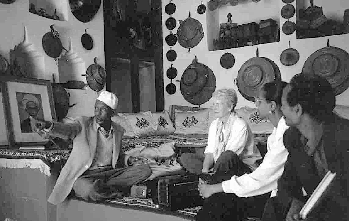 A storyteller gestures as Elizabeth Laird and others listen in the former Emir’s Palace in Harar